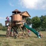 Backyard Discovery Eagles Nest Cedar Wooden Playhouse Playset with 7-Foot Crow's Nest Wave Slide and Rock Climbing Wall - Image 2
