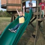 Backyard Discovery Eagles Nest Cedar Wooden Playhouse Playset with 7-Foot Crow's Nest Wave Slide and Rock Climbing Wall - Image 6