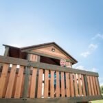 Backyard Discovery Eagles Nest Cedar Wooden Playhouse Playset with 7-Foot Crow's Nest Wave Slide and Rock Climbing Wall - Image 7
